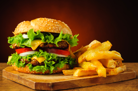 Photo of hamburger and french fries on a wooden platter